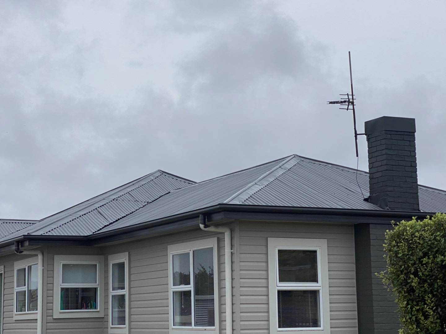 Country home in soft Tassie light with dark grey metal roof